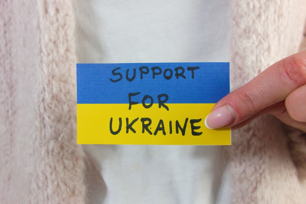 The flag of Ukraine on a paper with words 